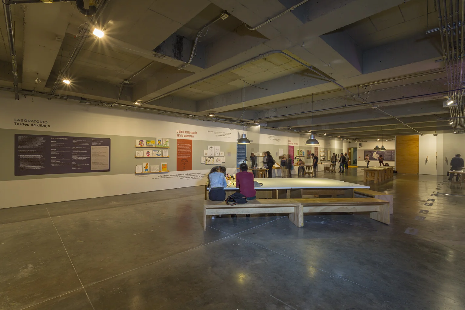 main room: workshop tables on the axis — Facing the other